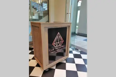 a small tv on a checkered floor at Regency Apartment Hotel Menlyn in Pretoria
