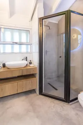 a bathroom with a glass shower and a sink at Waterfront Serenity View in Hartbeespoort