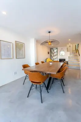 a dining room with a wooden table and chairs at Waterfront Serenity View in Hartbeespoort