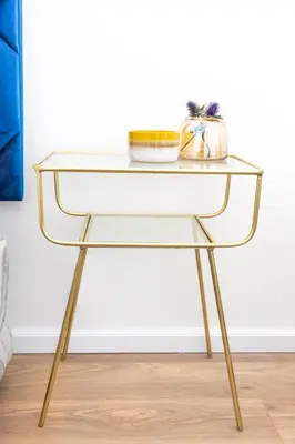 a console table with a glass top and gold legs at Waterfront Serenity View in Hartbeespoort
