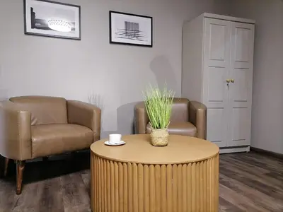 a living room with two chairs and a table at HWH Guesthouse Middelburg in Middelburg