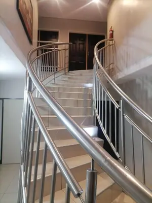 a staircase in a building with metal railing at HWH Guesthouse Middelburg in Middelburg