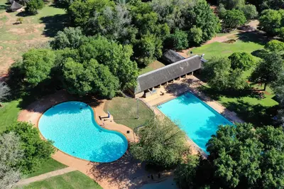 an overhead view of two swimming pools in a park at Tshipise A Forever Resort in Tshipise