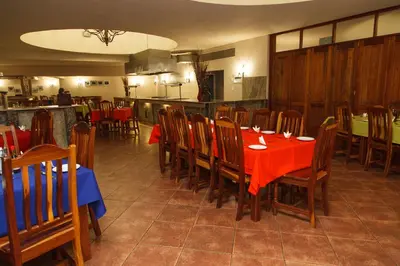 a dining room with a red table and chairs at Tshipise A Forever Resort in Tshipise
