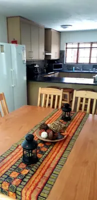 a kitchen with a table with a plate of food on it at Lovely holiday home for a large family or friends bordering Kruger National Park in Marloth Park