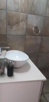a white sink on a counter in a bathroom at Lovely holiday home for a large family or friends bordering Kruger National Park in Marloth Park