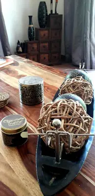 a wooden table with a basket on top of it at Lovely holiday home for a large family or friends bordering Kruger National Park in Marloth Park