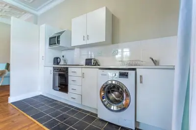 a kitchen with a washer and a dishwasher at Middelberg Manor in Pretoria