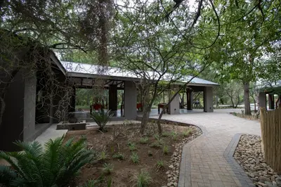 a building with a walkway in a park at Little Africa Safari Lodge in Hoedspruit