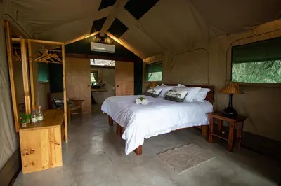 a bedroom with a bed in a tent at Little Africa Safari Lodge in Hoedspruit