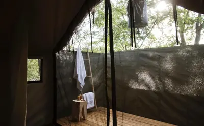 a room with a tent with a towel hanging from it at Simbavati Trails Camp in Timbavati Game Reserve