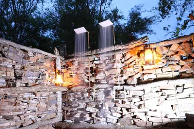a stone wall with lights on it at night at Sable Creek Safari Lodge in Tzaneen