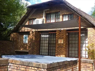 an old brick house with a mattress in front of it at Weltevrede Lodge - Self Catering Houses in Marloth Park