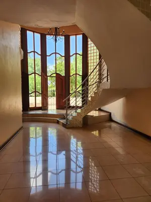 an empty room with a staircase and a floor at Fhamoni House in Centurion
