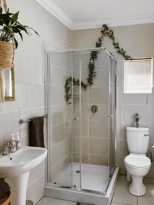 a bathroom with a shower and a toilet and a sink at Rondebossie Farm Retreat in Magoebaskloof