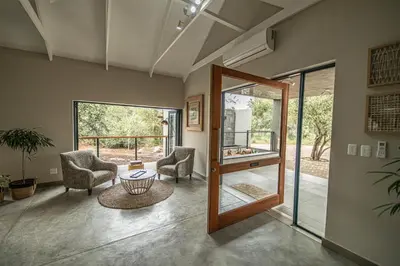 a living room with two chairs and a table at Little Kubu Lodge in Hoedspruit