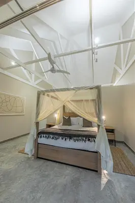 a large bedroom with a bed with a canopy at Little Kubu Lodge in Hoedspruit
