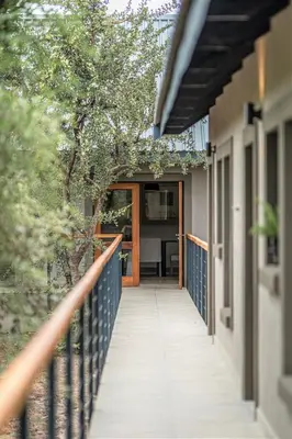 a walkway leading to a house with a porch at Little Kubu Lodge in Hoedspruit