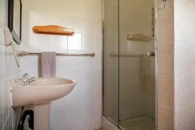 a bathroom with a sink and a glass shower at Moonlight Meadows just outside Dullstoom in Dullstroom