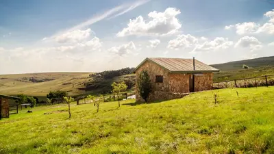 an old stone building in a field of grass at Moonlight Meadows just outside Dullstoom in Dullstroom