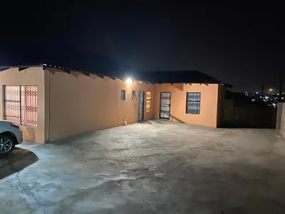 an empty parking lot in front of a building at night at Mankweng lodge in Polokwane