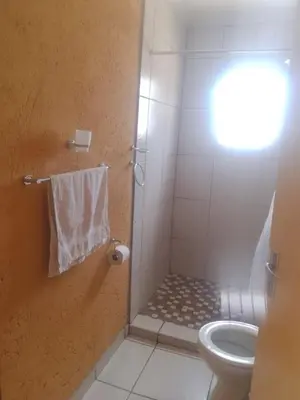 a bathroom with a shower and a toilet at Mankweng lodge in Polokwane