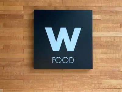 a sign that says w food on a wooden floor at Menlyn Maine Trilogy 11th Floor in Pretoria