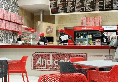 a restaurant with two chefs preparing food in the kitchen at Menlyn Maine Trilogy 11th Floor in Pretoria