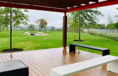 a wooden deck with a bench and a yard at Menlyn Maine Trilogy 11th Floor in Pretoria
