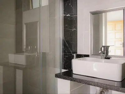 a bathroom with a sink and a mirror at Serene Pastures in Midrand