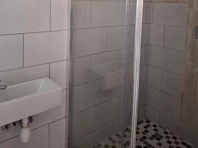 a bathroom with a sink and a shower at Serene Pastures in Midrand