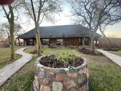 a building with a stone planter in front of it at No 43 - The Eco Lodge in Hoedspruit
