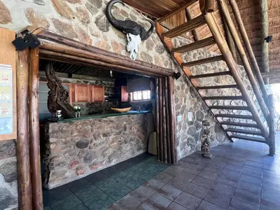 an attic room with a stone wall at No 43 - The Eco Lodge in Hoedspruit