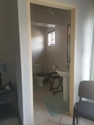 a bathroom with a toilet and a sink at Klyne Jiweel Guesthouse in Pretoria