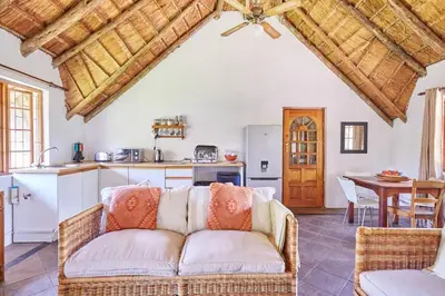 a living room with a couch and a kitchen at 41 Ridge- self catering cottages in Midrand