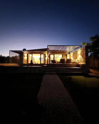 a house lit up at night with lights at Lira Boutique Lodge in Thohoyandou