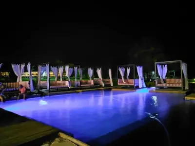 a swimming pool at night with blue lights at Lira Boutique Lodge in Thohoyandou