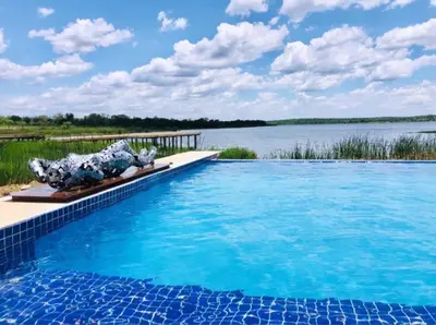 a swimming pool with a view of a lake at Lira Boutique Lodge in Thohoyandou