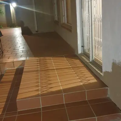a hallway with a tiled floor next to a door at Langa's Gabedi Goshen in Pretoria
