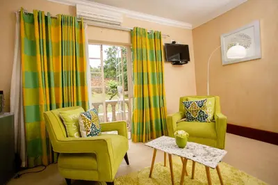 a living room with two chairs and a table at TDM's Boutique Guest House in Pretoria