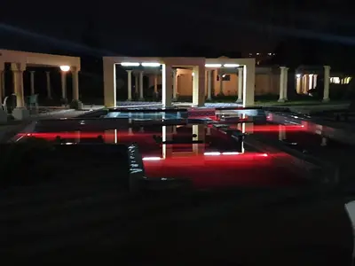 a swimming pool at night with red lights at Floreat Riverside Lodge and Spa in Sabie
