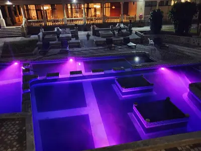a swimming pool with purple lights in a building at Floreat Riverside Lodge and Spa in Sabie