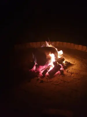a fire burns in a brick oven at night at Makhato Bush Lodge 86 in Bela-Bela