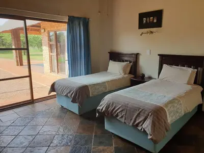 two beds sitting next to each other in a bedroom at Makhato Bush Lodge 86 in Bela-Bela