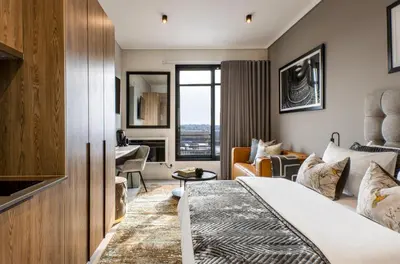 a hotel room with a bed and a living room at Menlyn Maine Residence Unit 1419 & 1028 in Pretoria