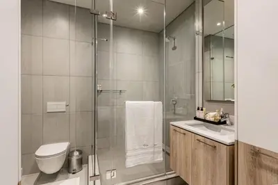 a bathroom with a shower and a toilet and a sink at Menlyn Maine Residence Unit 1419 & 1028 in Pretoria