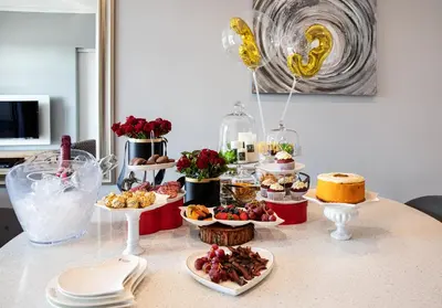 a table with various desserts and cakes on plates at Menlyn Maine Residence Unit 1419 & 1028 in Pretoria