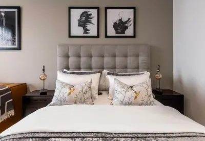 a bedroom with a large bed with white sheets and pillows at Menlyn Maine Residence Unit 1419 & 1028 in Pretoria