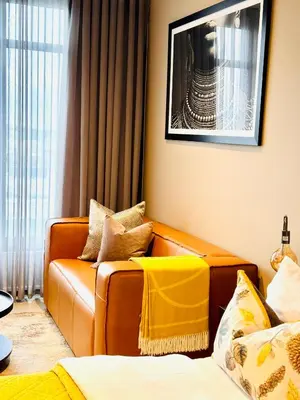 a living room with a couch and a chair at Menlyn Maine Residence Unit 1419 & 1028 in Pretoria