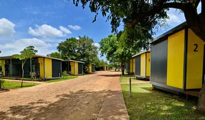 a row of houses on a dirt road at SleepOver Komatipoort in Komatipoort